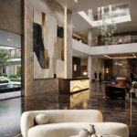 Onyx Ascension black and gold abstract painting displayed in a luxury double-height hotel lobby